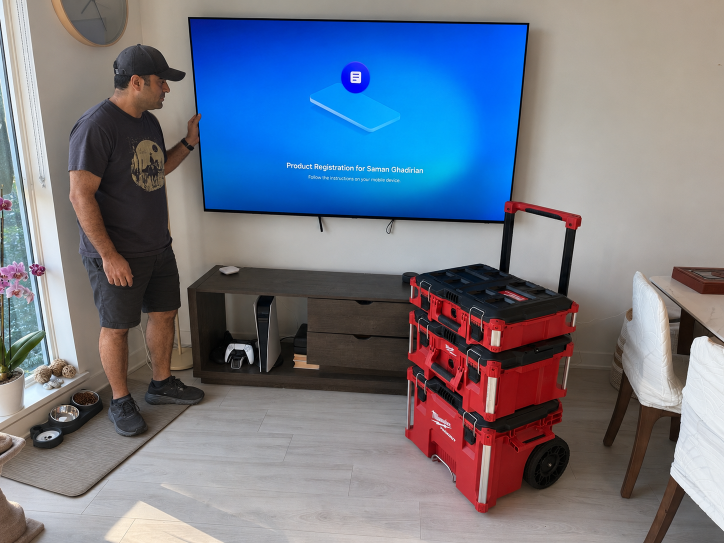 Makto technician mounting a TV in a modern living room